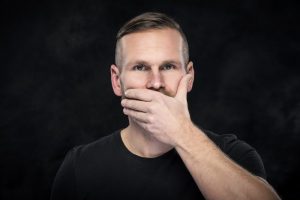 man covering mouth